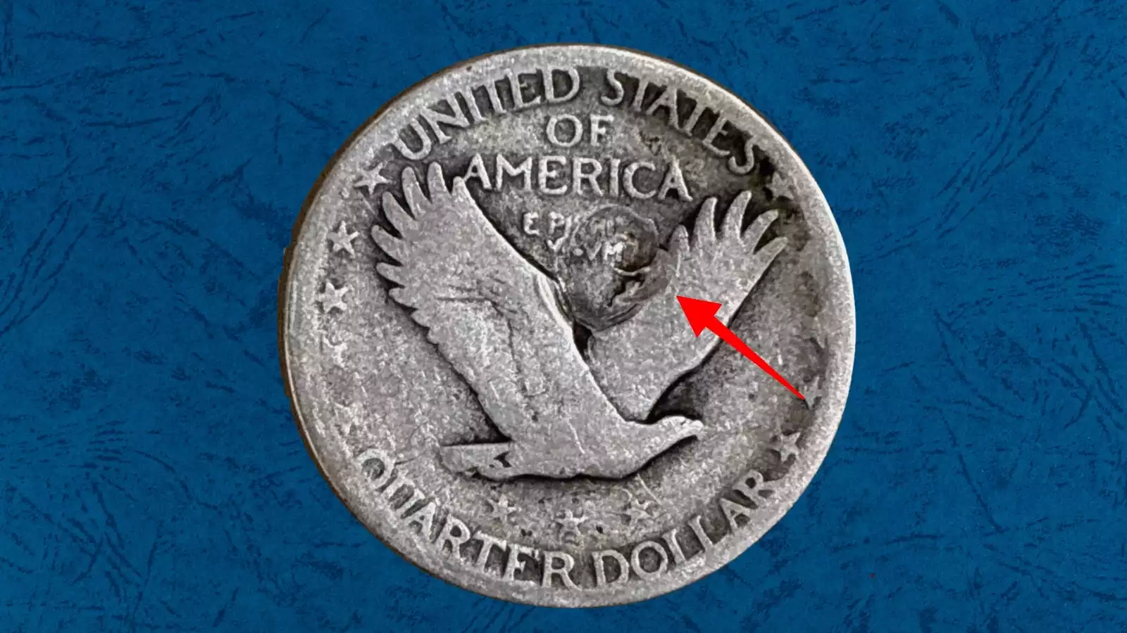 Close-up of 1926 Standing Liberty quarter struck-through error showing impression from debris trapped during striking